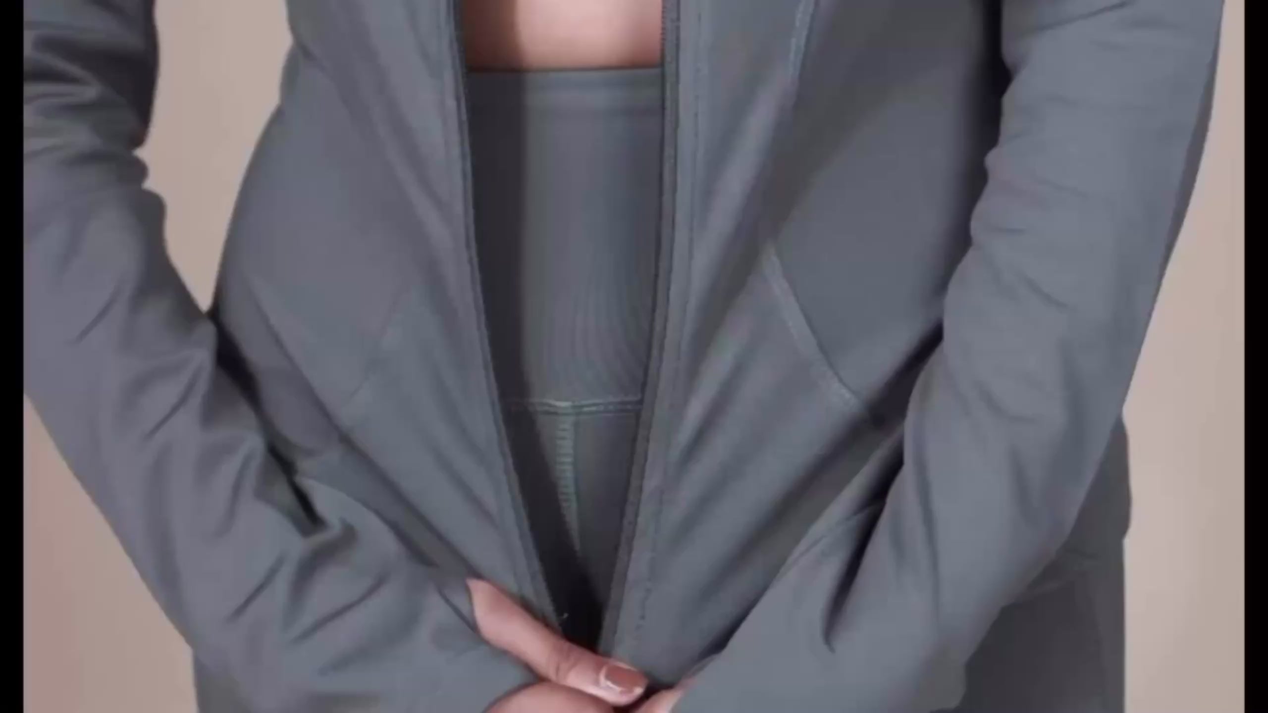 Load video: Women wearing the Snug Zipper activewear set with a front-zip sports bra and high-waisted leggings, posing and moving in a gym/studio setting to showcase the fitted silhouette, stretch fabric, and supportive design.